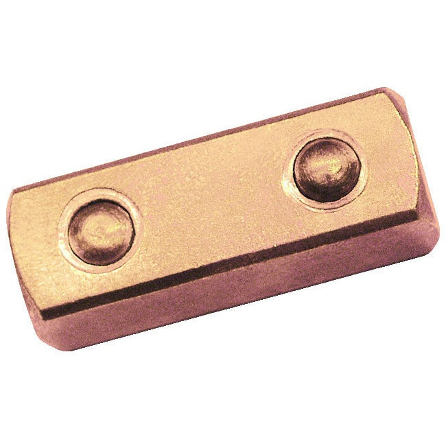 Cuadradillo pasante 1/4" ATEX: Bloque metálico rectangular con dos cavidades circulares en la cara superior