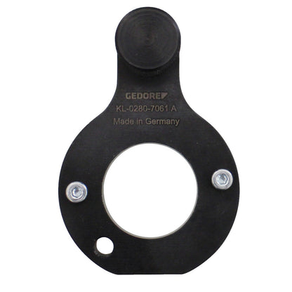 KL-0280-7061 A - Herramienta de bloqueo del cigüeñal: Placa negra circular con orificio central, dos tornillos
